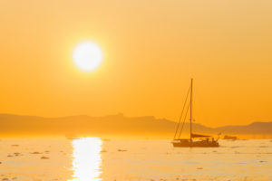Sailing ship in icefjord with sun, Greenland, Ilulissat, Icefjord Sailing ship in icefjord with sun, Greenland, Ilulissat, Icefjord